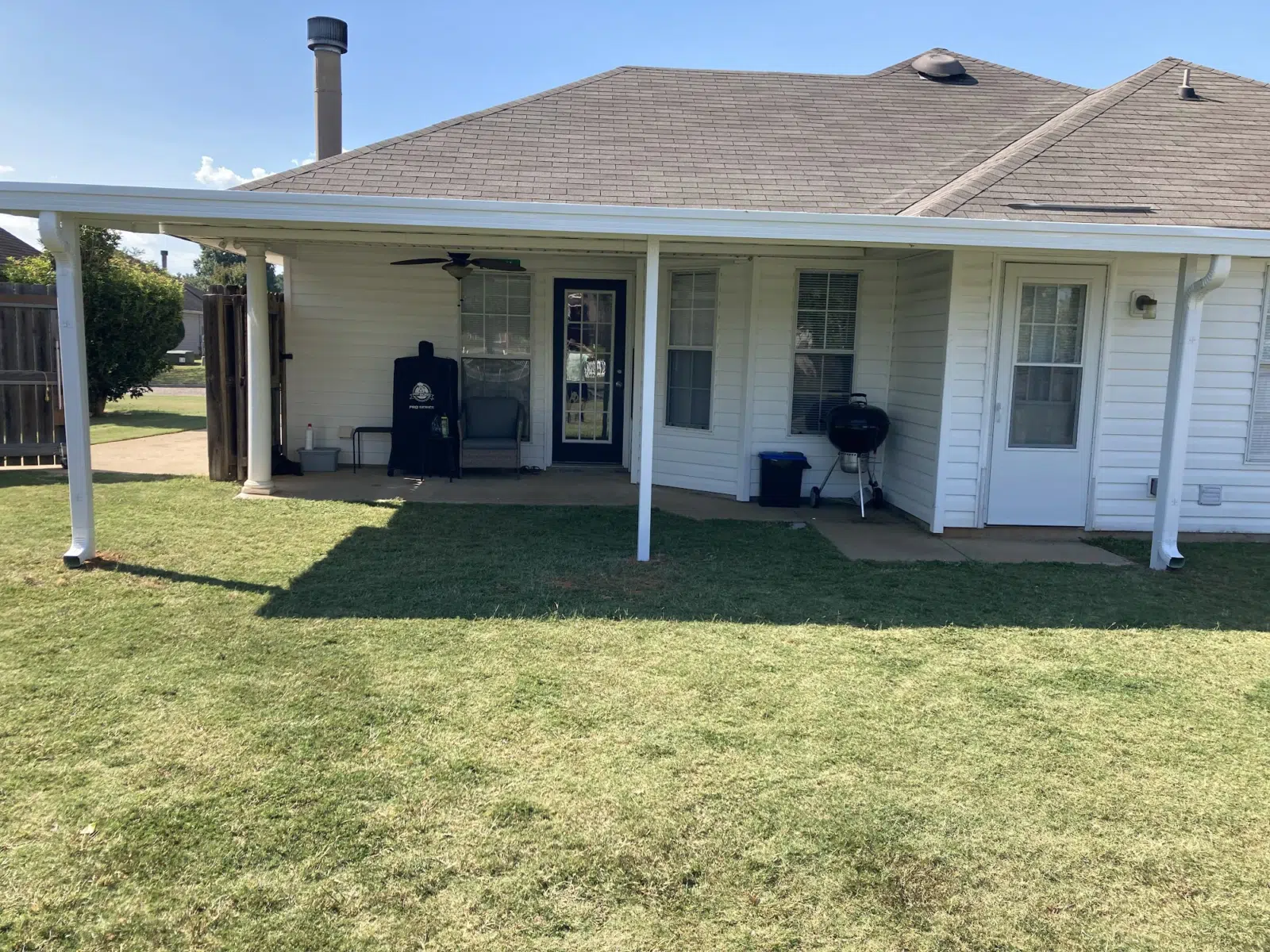 White aluminum patio cover along the back of a house — Three Rivers Aluminum Awnings, LLC. in Dothan