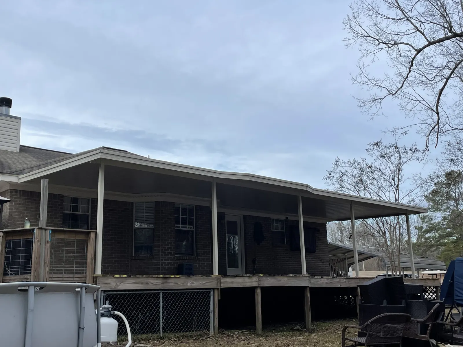 Aluminum patio cover over a raised deck, seen from the backyard